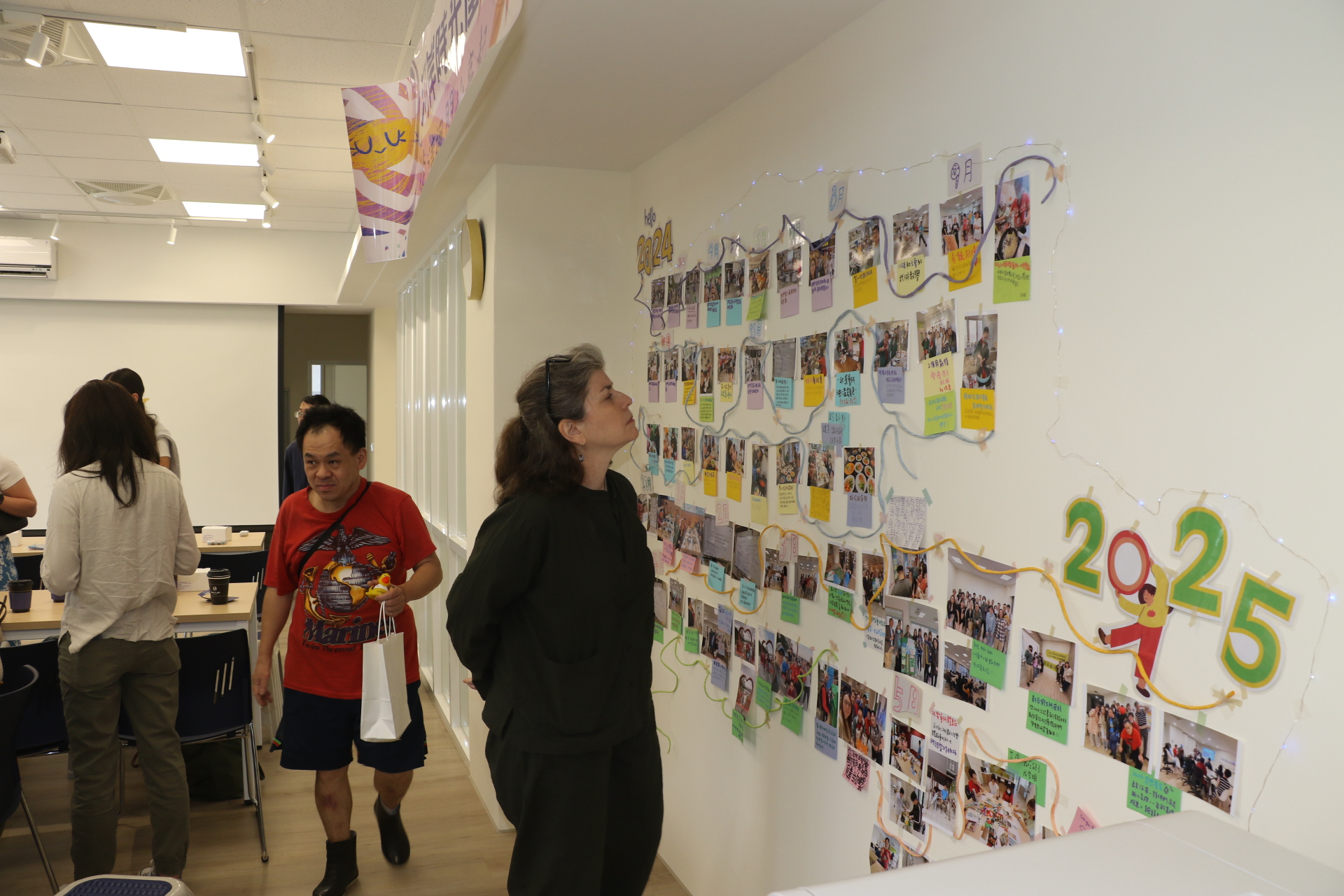 Rutgers University students look at photos of clubhouse operations and activities.